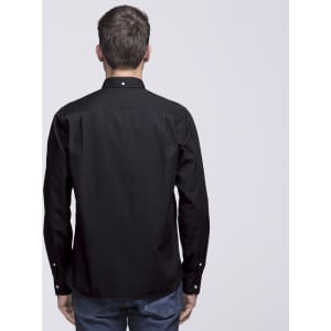 A black button-up shirt viewed from the back, featuring long sleeves and a collar. It has a small logo on the back.