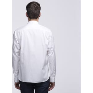 A white button-up shirt viewed from the back, featuring a collar and long sleeves. It has a logo on the back.