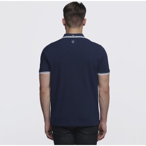 A navy blue polo shirt with contrasting white trim, featuring a logo on the back.