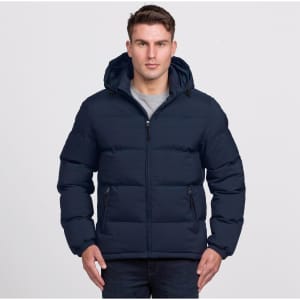 A navy puffer jacket with a hood and zip-up front, featuring side pockets. The model is wearing it with a grey top.