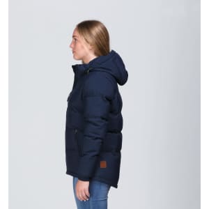 A navy blue puffer jacket with a hood, featuring a logo and side zip pockets, displayed on a model from the side.