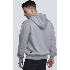 A grey vintage hoodie with a hood, featuring a logo on the side, displayed on a male model from behind.