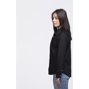 A black button-up shirt with a collared design, featuring a logo, displayed on a model from the side.
