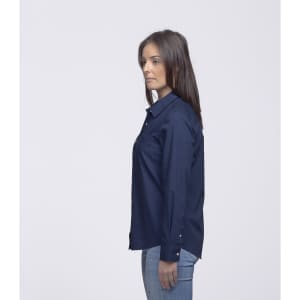 A side view of a woman wearing a navy button-up shirt, featuring a logo on the sleeve.