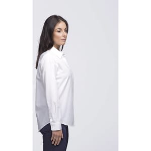A white button-up shirt on a woman, featuring a simple design and a logo on the shirt.