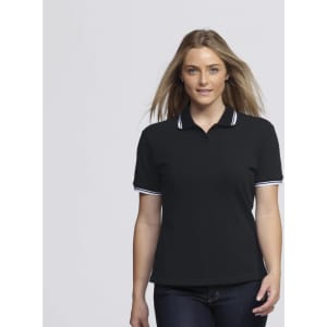 A woman in a black polo shirt with white trim, featuring a logo on the chest. She has long hair styled down.