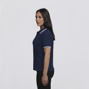 A navy women's polo shirt with a classic collar and white trim, displayed on a model from the side.