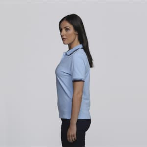 A light blue women's polo shirt with contrasting trim and a logo on the chest.