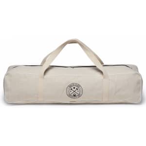 A beige canvas bag with handles, featuring a circular logo, designed for storing a croquet set.