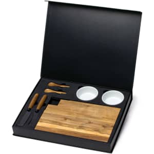 A gourmet cheese set in a black box featuring a wooden board, knives, and two small white bowls.