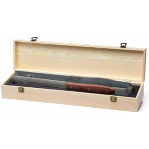 A pair of stainless steel BBQ tongs with a wooden handle, presented in a wooden box. The box has a smooth finish.