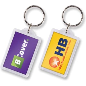 A rectangular lens key ring featuring two different coloured areas and including logos on both sides.