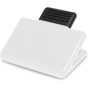 A white magnetic clip with a black gripping section. The clip is designed for holding papers or notes.