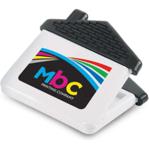 A house-shaped magnetic clip in white and black with a logo on the front.