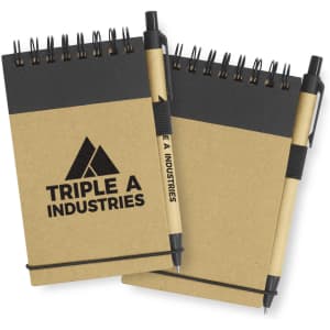 A Spiro Notebook in natural brown with a black top section, accompanied by a black pen and featuring a branding logo.