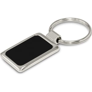 A rectangular metal key ring with a shiny silver finish and a black etched surface, featuring a logo.