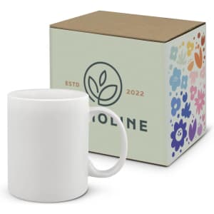 A white coffee mug sits alongside a patterned box featuring floral designs and a logo.