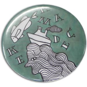 A round, 58mm button badge featuring a green background with abstract white line art and a logo.