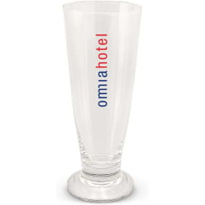 A tall glass beer glass with a clear, smooth surface and a base, featuring a logo in red and blue.
