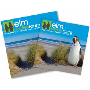 Promotional cleaning cloths featuring a coastal scene with grass and a penguin, in vibrant colours and a logo.
