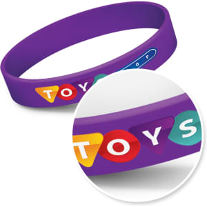 A purple silicone wristband featuring colourful circular designs and a branding logo.