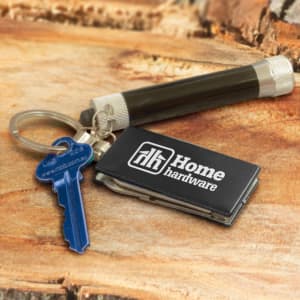 A multi-function metal key ring in silver, attached to a blue key and a small black device with a logo.