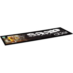 A large black counter mat featuring a drink glass and a logo. The design includes white and silver elements.