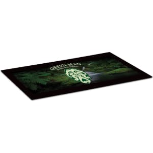 A small counter mat featuring a green design with a nature theme and a logo. The mat has a black border.