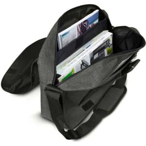 A grey satchel bag with an adjustable strap, featuring open compartments filled with magazines and documents.