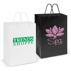 Two large laminated carry bags are displayed: one white with green branding and the other black with pink branding.