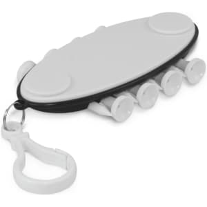 A white and black golf accessory with multiple small compartments and a clip attachment. It features a branding logo.