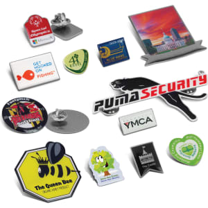 A collection of colourful lapel badges in various shapes and designs, featuring logos and images.