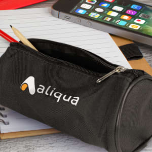 A black pencil case with a zip, featuring a logo, holding a pencil and placed on a notepad next to a smartphone.