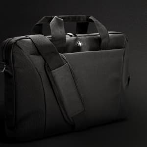 A black Swiss Peak 38cm laptop bag with dual handles and a detachable shoulder strap. Features a solid design and logo.