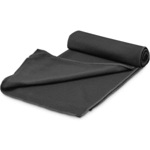 A rolled black cooling towel made of textured fabric, laid out flat. It features a logo on one side.