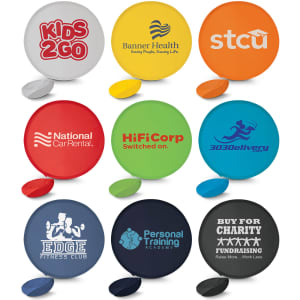 A set of colourful flying discs in various designs, featuring logos and names. The discs are round and made from plastic.
