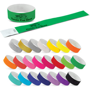 A collection of Tyvek event wristbands in various colours, featuring a roll and several individual bands.