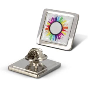 A square lapel pin featuring a vibrant rainbow design with a silver backing. It includes a logo on the front.