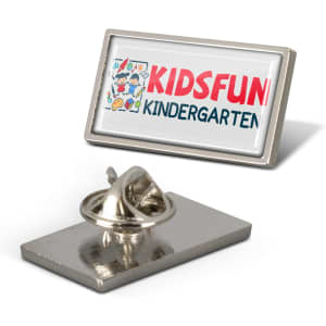 A rectangular silver lapel pin featuring a colourful logo and a secure fastening mechanism on the back.