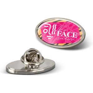 An oval lapel pin featuring a pink and multicoloured design with a logo. The back has a pin attachment.