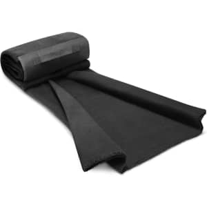 A rolled Yukon Fleece Blanket in a solid black color is displayed, showcasing its soft texture and clean edges.