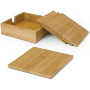 A set of bamboo coasters in natural wood colour, stacked beside a matching bamboo holder.