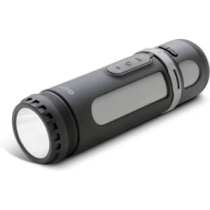 A grey Swiss Peak 4-in-1 speaker, designed like a flashlight, features buttons and a clear lens at one end.