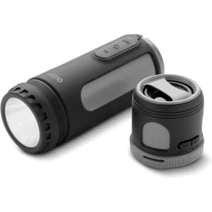 A black Swiss Peak 4-in-1 speaker with a detachable compartment, features controls on the side, and a branded logo.