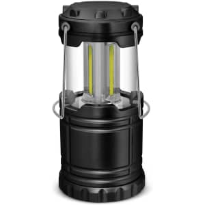 A black COB lantern with a transparent body and dual light strips, featuring a sturdy design and handle for carrying.