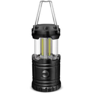A compact black lantern with a clear casing and a handle, featuring two internal yellow lights.
