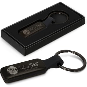 A black rectangular key ring in a gift box, featuring a key ring attachment and a logo.