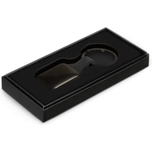 A key ring in a square shape is presented in a black box with a cushioned interior.