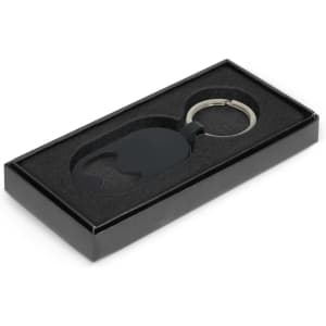 A drink bottle opener key ring in black, presented in a sleek black box with a foam insert.