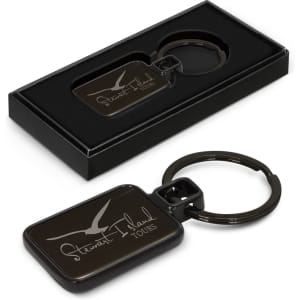 A black key ring with a rectangular design, presented in a sleek black box. Features a logo on the key ring.